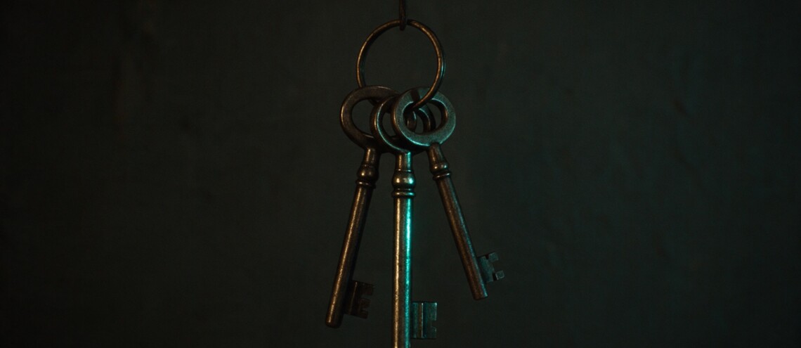 Three keys on a dark wall with one catching teal light — who holds decision rights on a website project — Dsignr Digital